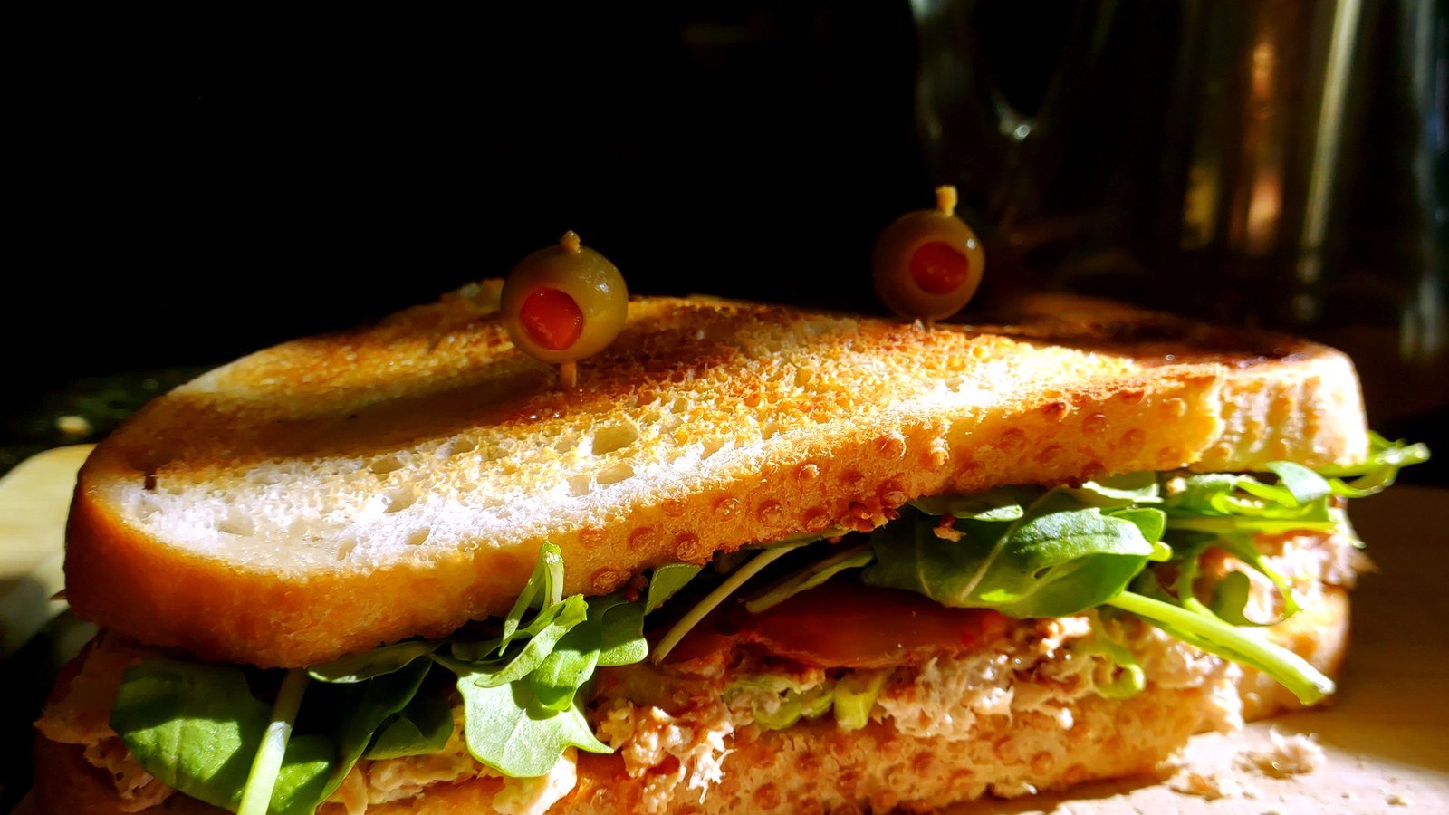 Toasted chicken salad sandwich with arugula