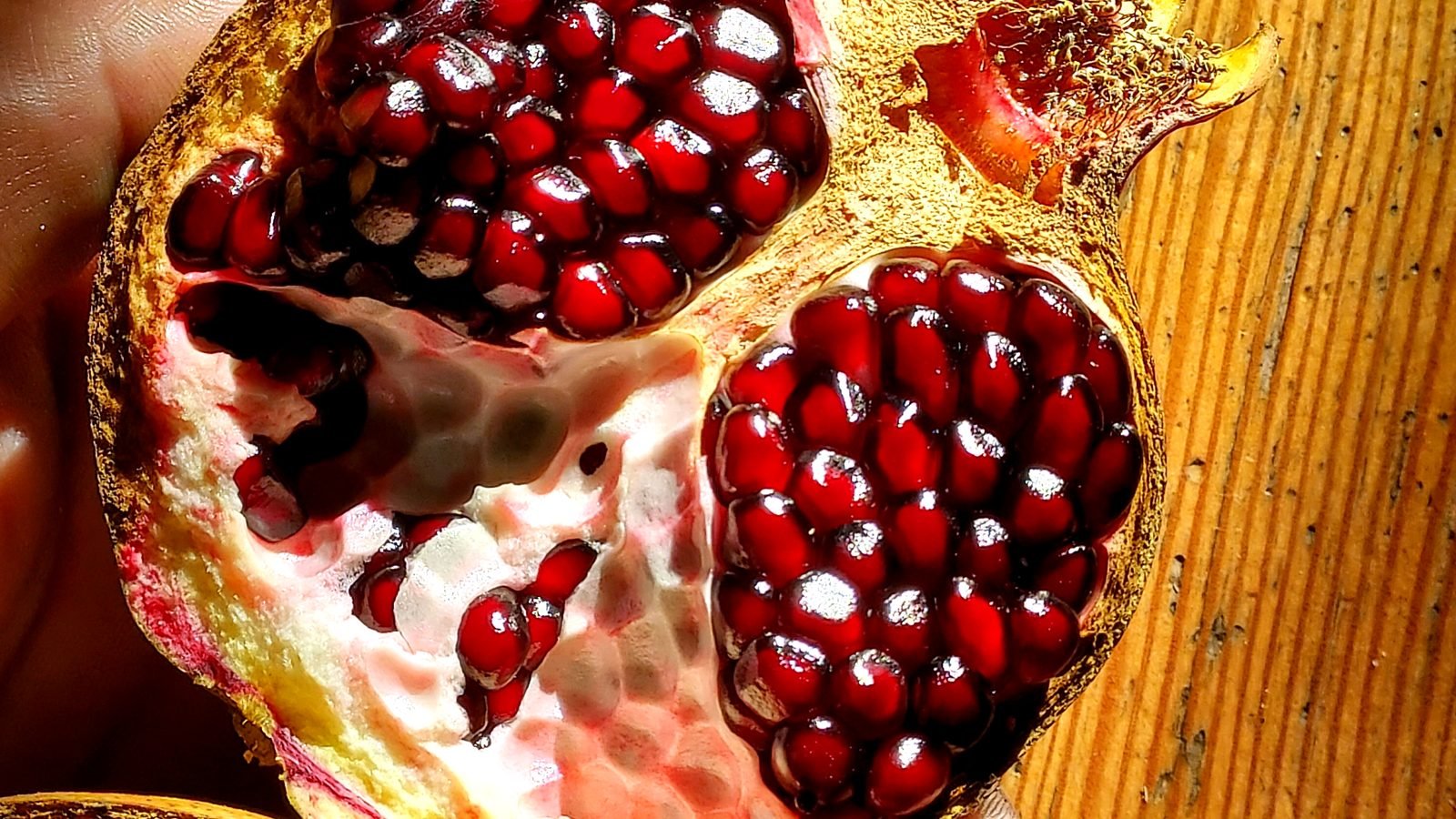 A pomegranate split open, seeds glistening