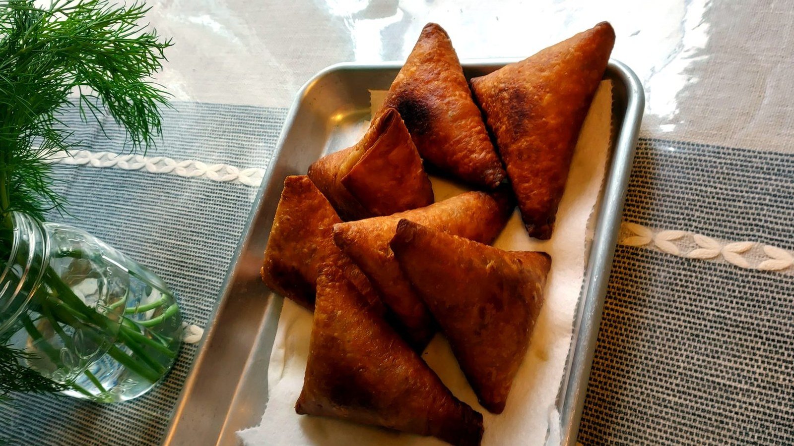 A tray of golden fried samosas