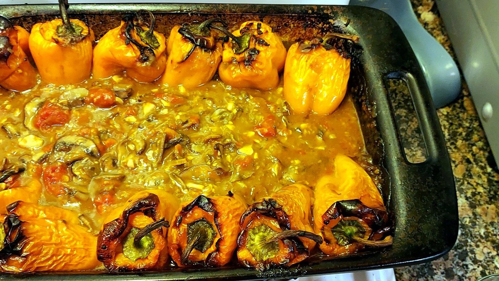 A tray of roasted stuffed peppers